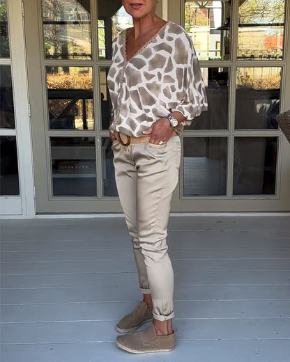 Elegante bedruckte Bluse mit V-Ausschnitt und Fledermausärmeln