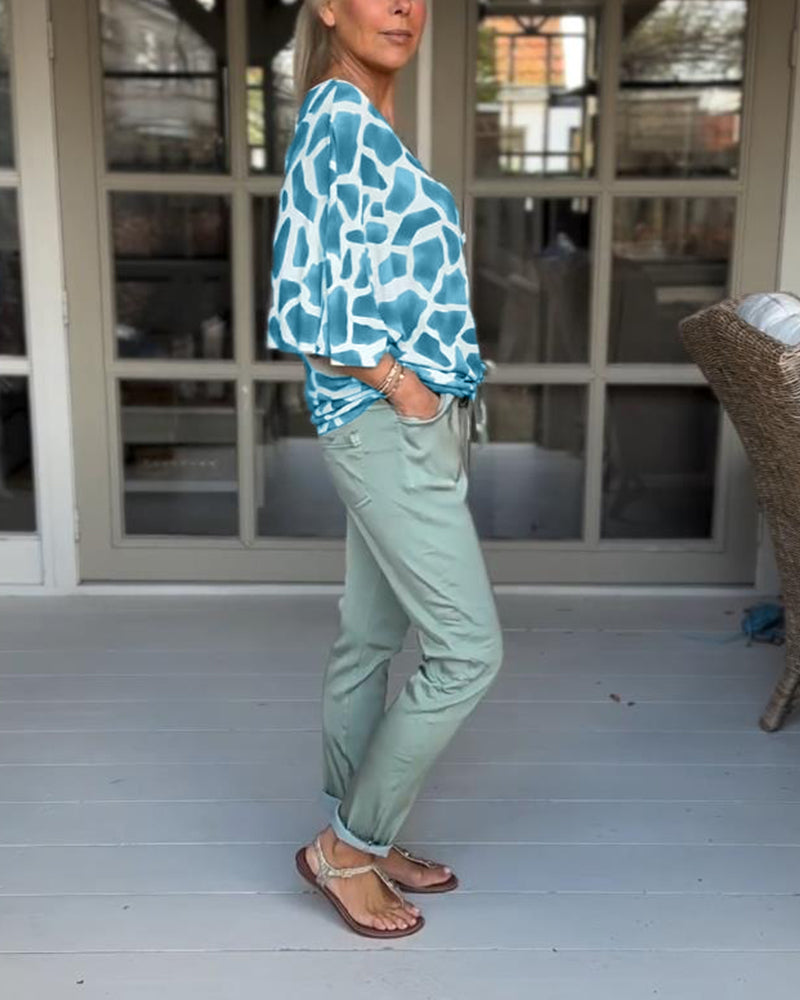 Elegante bedruckte Bluse mit V-Ausschnitt und Fledermausärmeln